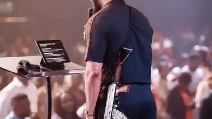 SHOCKING: Pastor Mounts Pulpit To Preach With AK-47 Rifle In Abuja (Video)