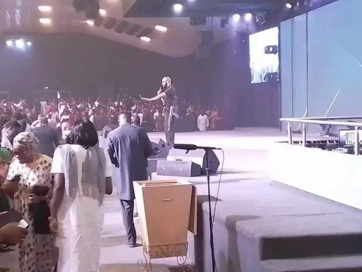 SHOCKING: Pastor Mounts Pulpit To Preach With AK-47 Rifle In Abuja (Watch Video)
