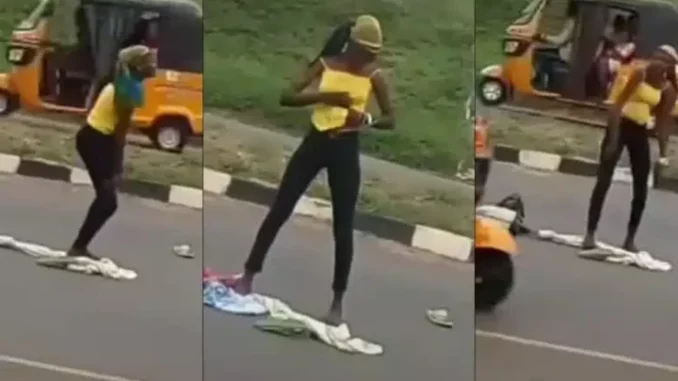 Lady runs mad after being dropped by an alleged yahoo boy in middle of a road (Video)